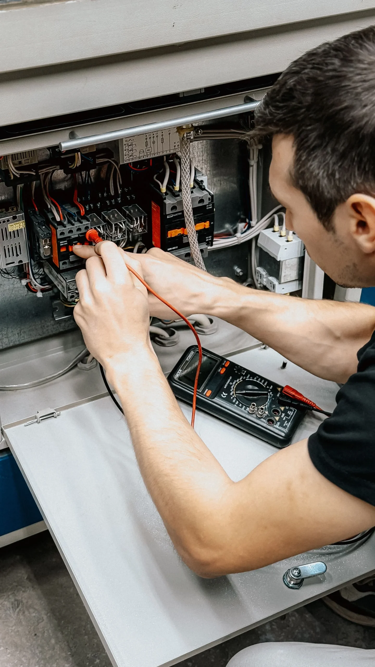 Técnico verificando con multímetro una instalación eléctrica antes del dictamen de la UVIE
